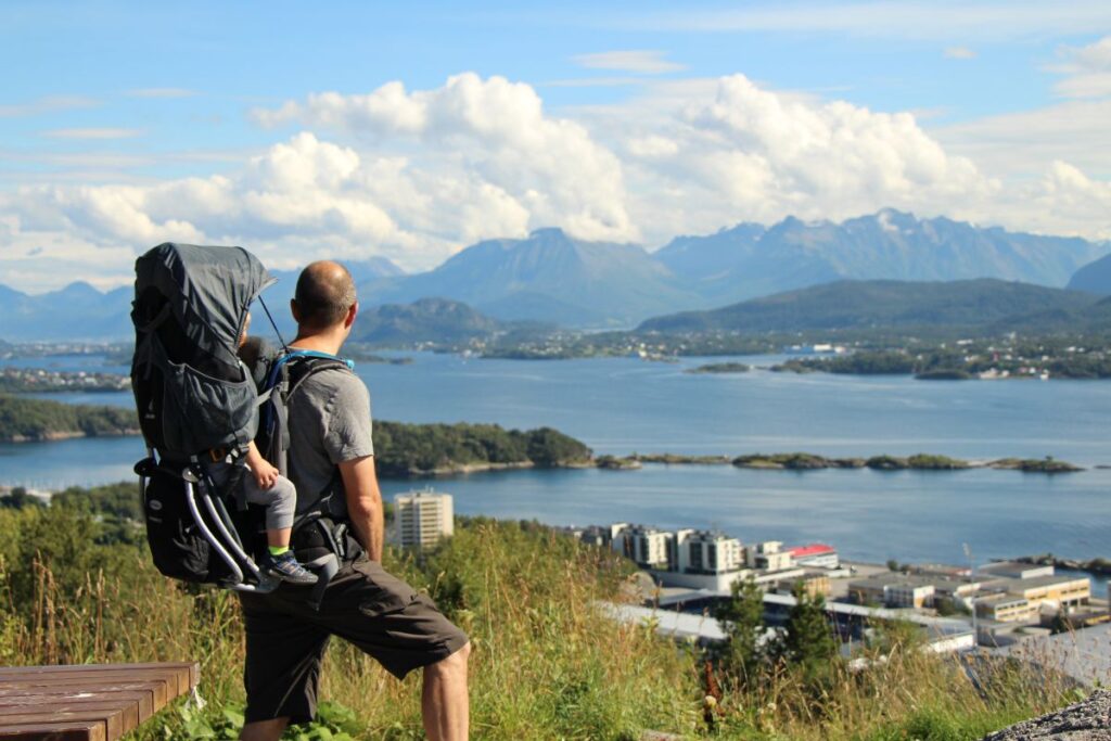 Dan Brewer, owner of FamilyCanTravel.com, carries his child in a Deuter backpack carrier while hiking in Norway with kids.