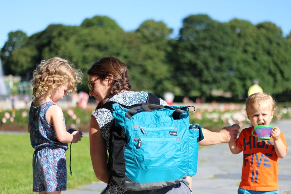 Celine Brewer, owner of FamilyCanTravl.com, carries a large diaper bag while visiting Oslo with kids.