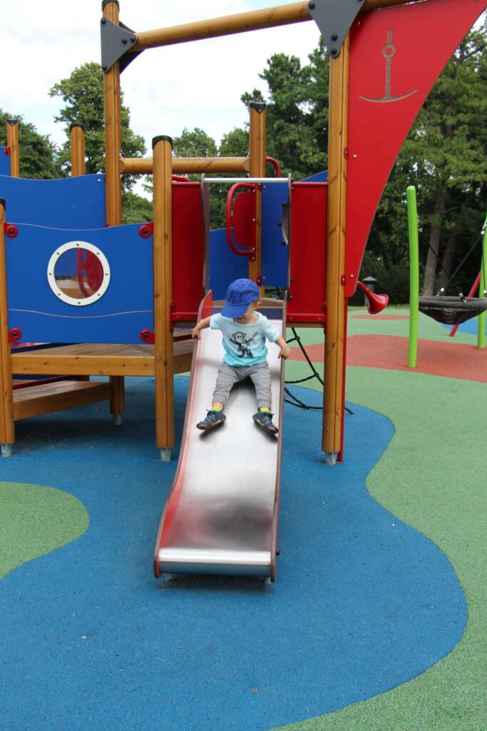 A 2-year old boy on a family trip to Olso, plays at a playground in Stensparken.