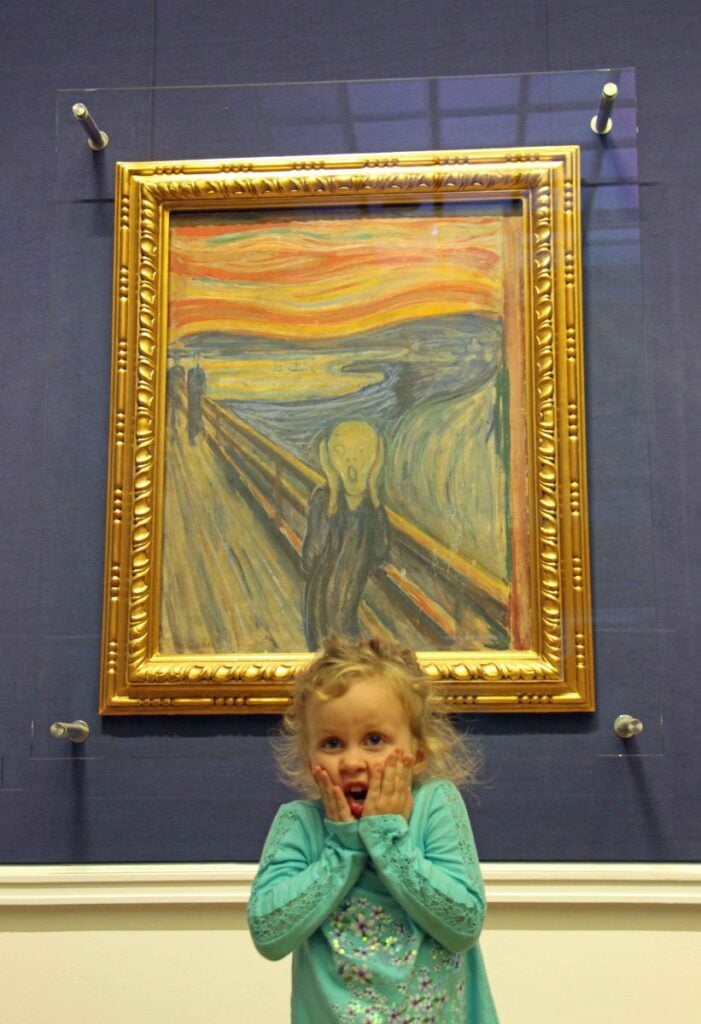 a 4-year old girl mimics the Scream painting by Edvard Munch on a family trip to Oslo.