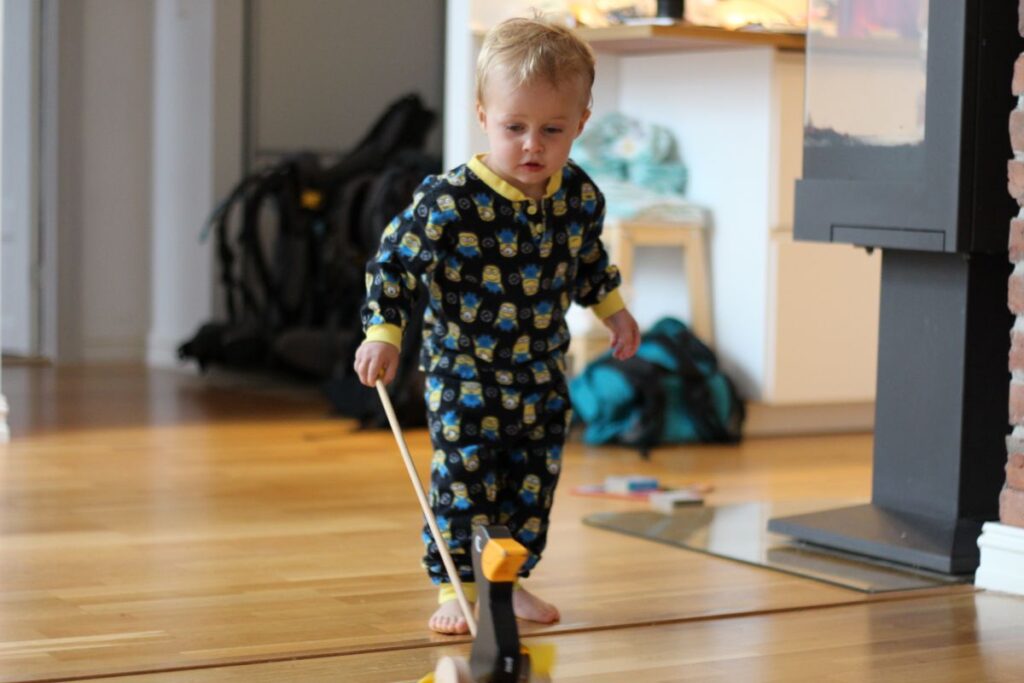 a 2-year old toddler plays with the toys found in our Oslo vacation rental.