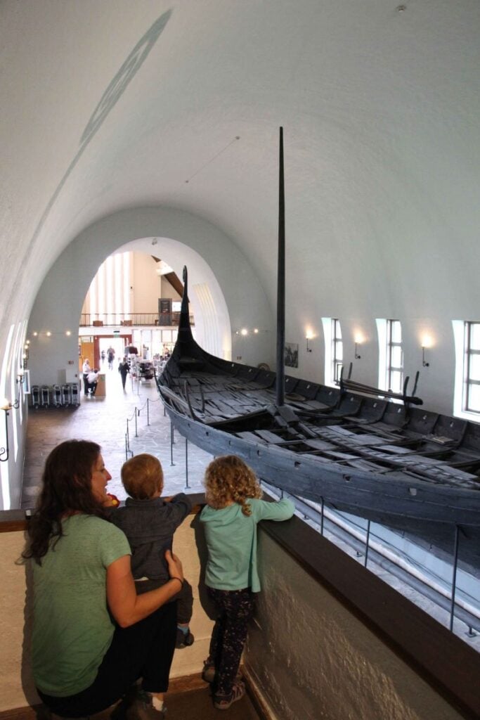 Celine Brewer, owner of FamilyCanTravel.com, looks at some old Viking ships at the Museum of the Viking Age in Oslo, Norway.