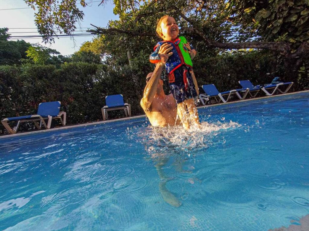 Dan Brewer plays with his son in the swimming pool at his Playa del Carmen vacation rental condo.