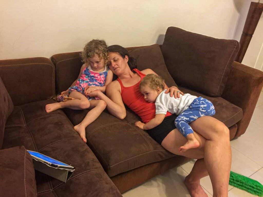 Celine Brewer, owner of the Family Can Travel blog, watches a movie on an iPad with her kids at their Playa del Carmen vacation rental.