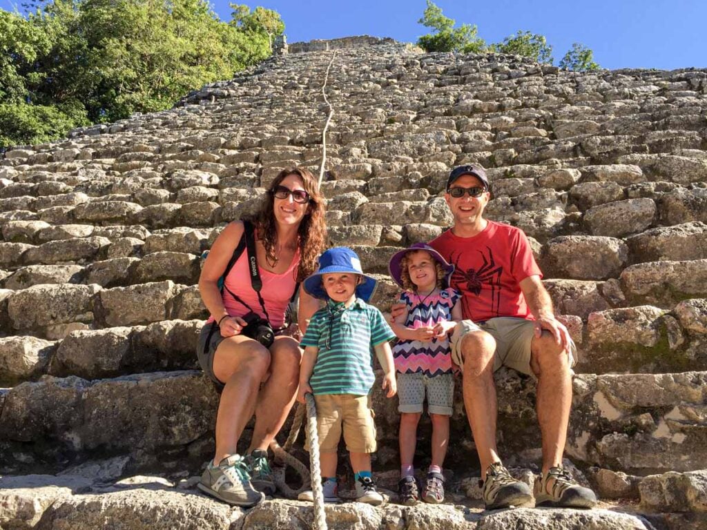 The Brewer family, from the Family Can Travel blog, sit on the stairs at the Coba ruins in the Yucatan Peninsula, Mexico.