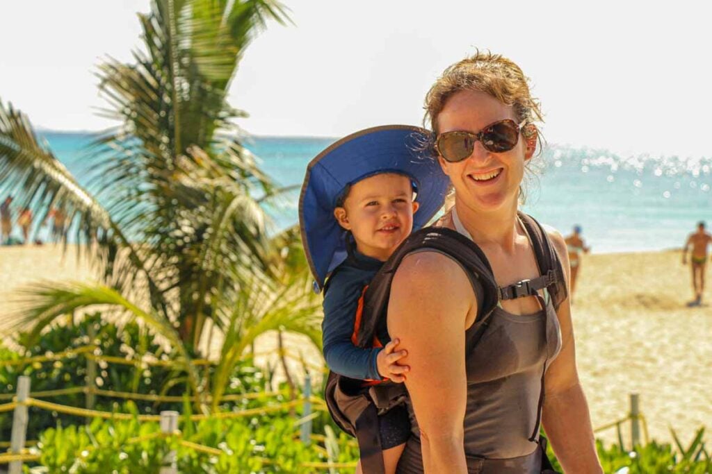 Celine Brewer, owner of Family Can Travel, walks with her son to the public beach near Fundadores Park in Playa del Carmen.