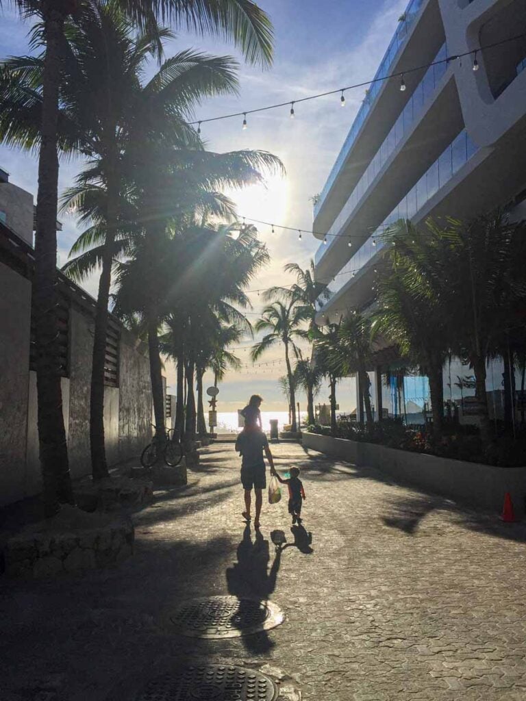Dan Brewer and his kids walk to the beach in Playa del Carmen at sunrise.