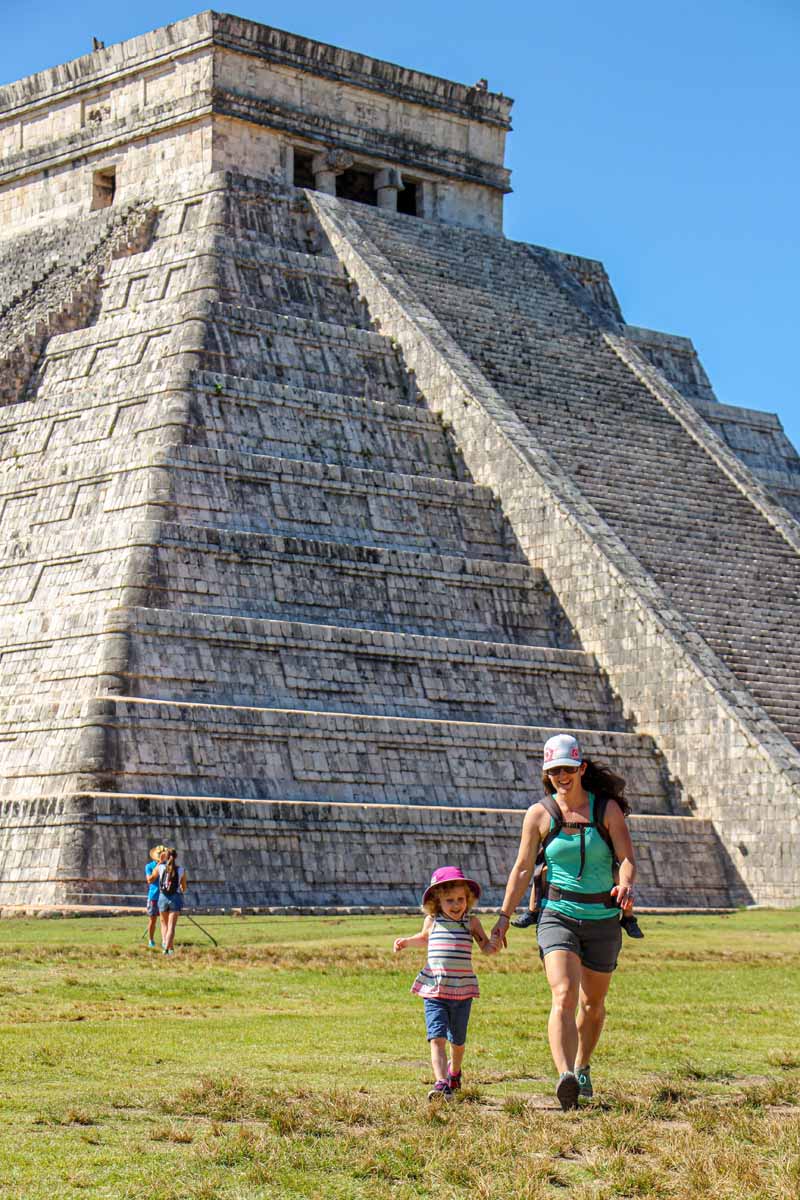 Celine Brewer, owner of FamilyCanTravel.com, walks with her daughter while exploring the Chichen Itza ruins on a family trip to Playa del Carmen, Mexico.