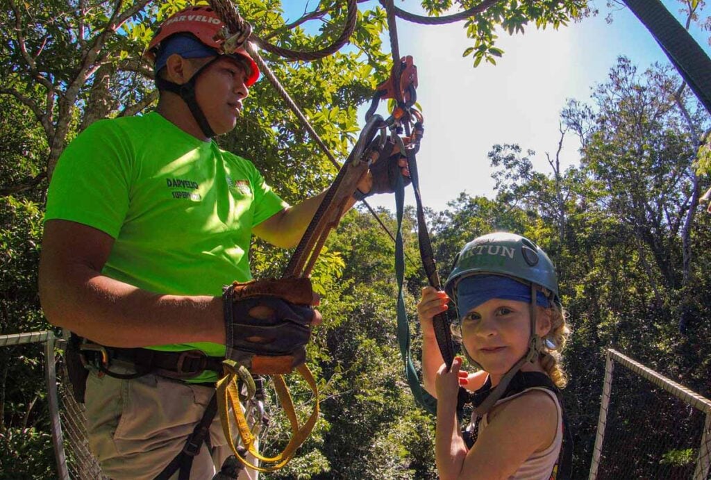 a young girl tries ziplining at the Aktun Chen theme park near Playa del Carmen, Mexico.