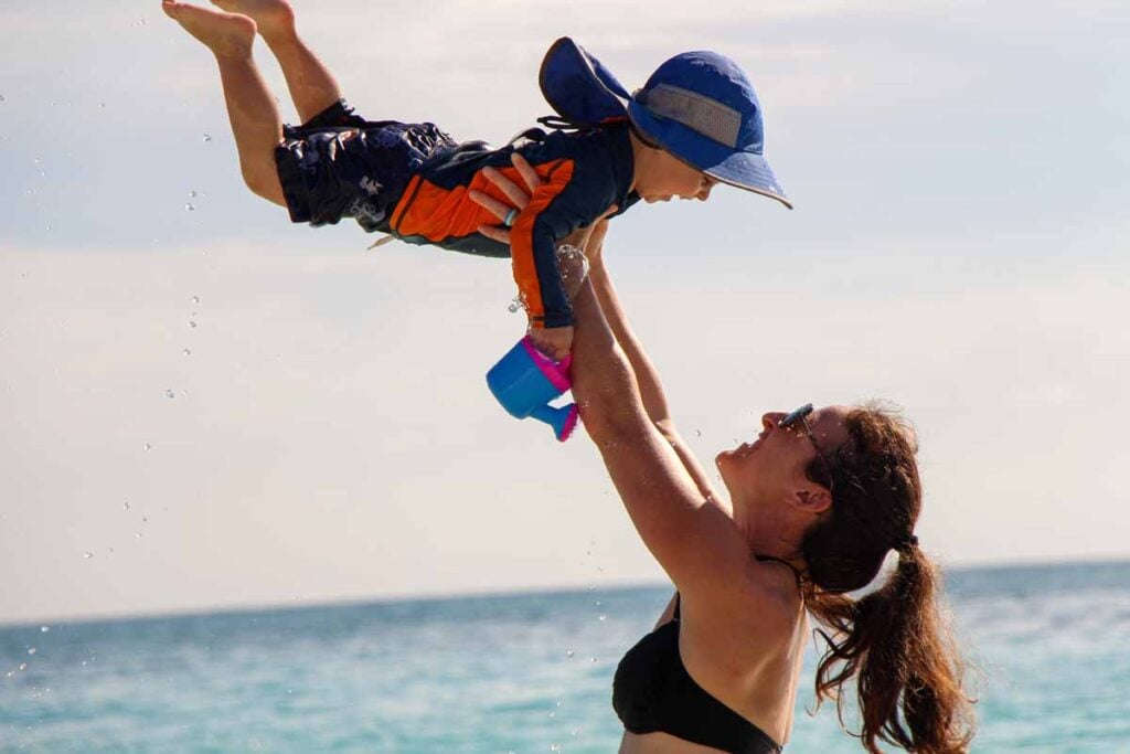 Celine Brewer, from the Family Can Travel blog, plays with her 2-year old son on Xpu-Ha beach on a family trip to the Riviera Maya.