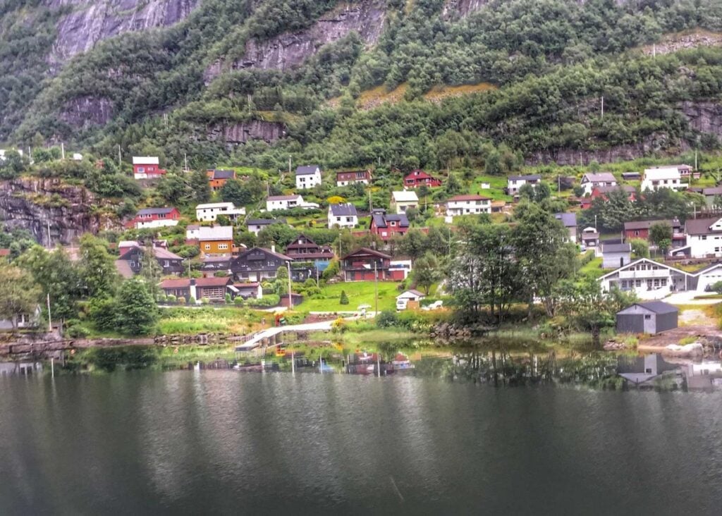 a colorful lakeside village as seen from the Oslo to Bergen train journey.