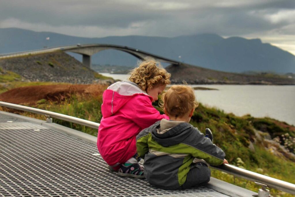 The Brewer kids, from the FamilyCanTravel blog, enjoy a walk on a boardwalk near the Atlantic Road while on a family road trip in Norway.