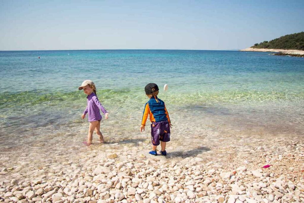 Kids playing on Milna Beach on Hvar Island Croatia - Best Beaches on Hvar with Kids