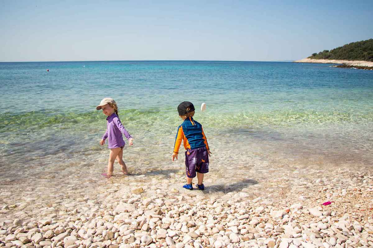 Kids playing on Milna Beach Hvar Island Croatia - Best Beaches Hvar with Kids