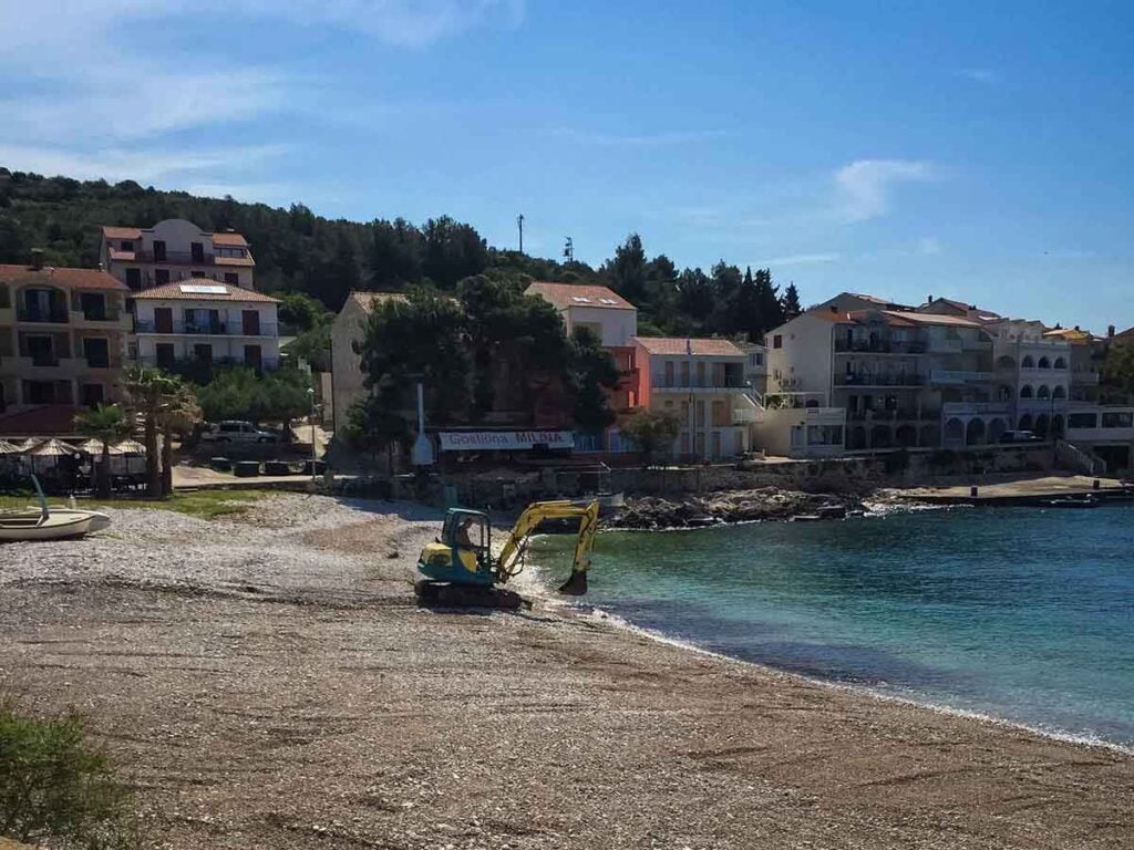 Crews preparing Milna Beach on Hvar Island Croatia