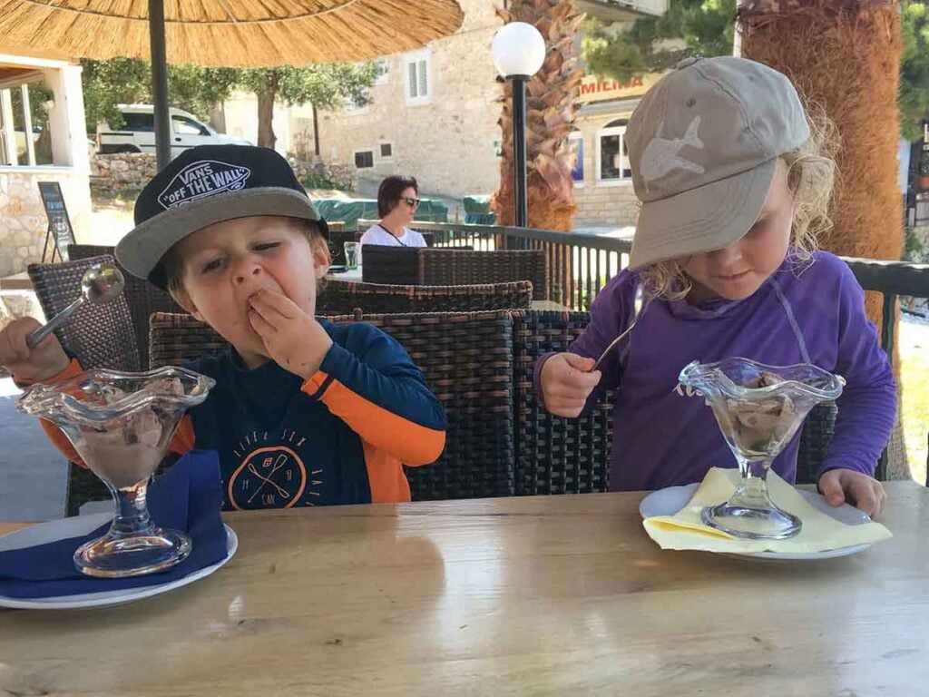 kids enjoying ice cream sundays in Milna Beach, near Hvar Town, Croatia