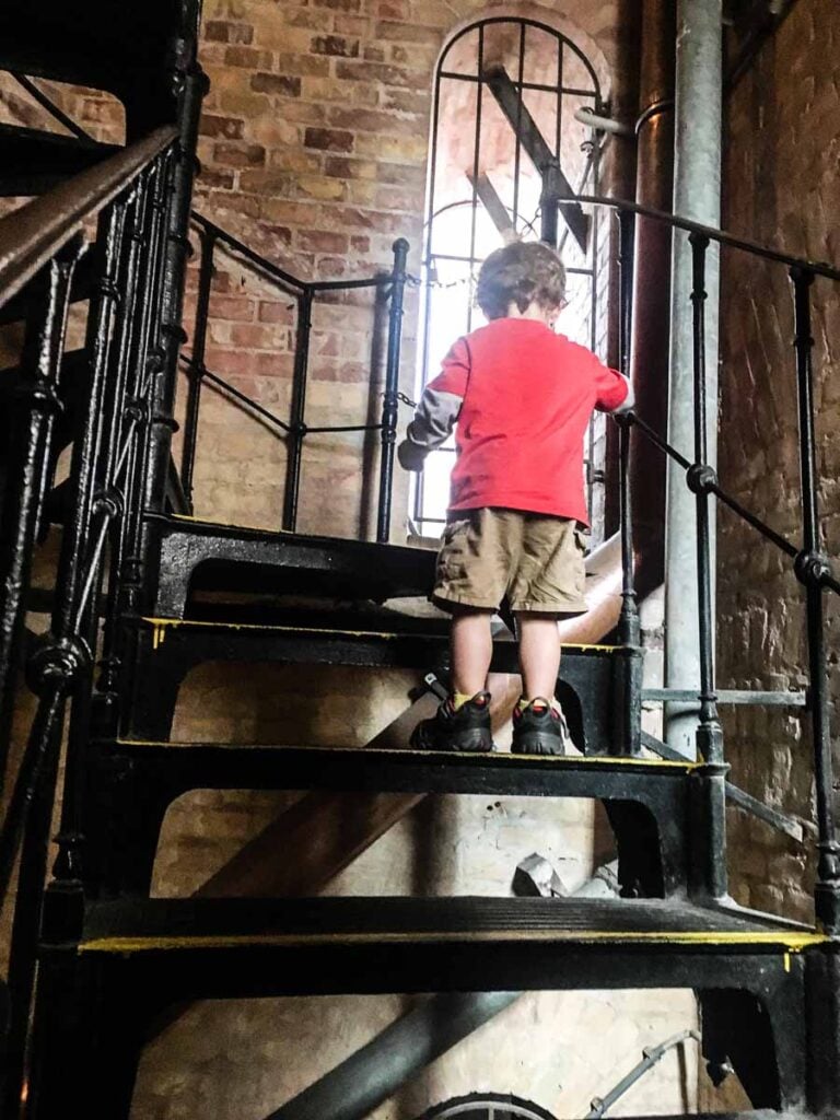a 2-year old boy climbs the bell tower at St Stephen's Basilica in Budapest, Hungary.