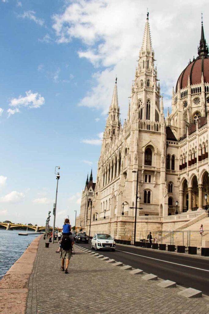 Dan Brewer carries his daughter on his shoulders as they walk past the Parliament Building in Budapest, Hungary.