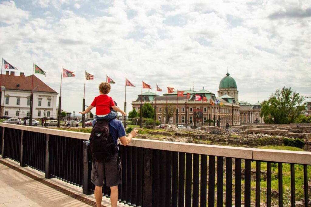 Dan Brewer carries his son on his shoulders near Buda Castle.