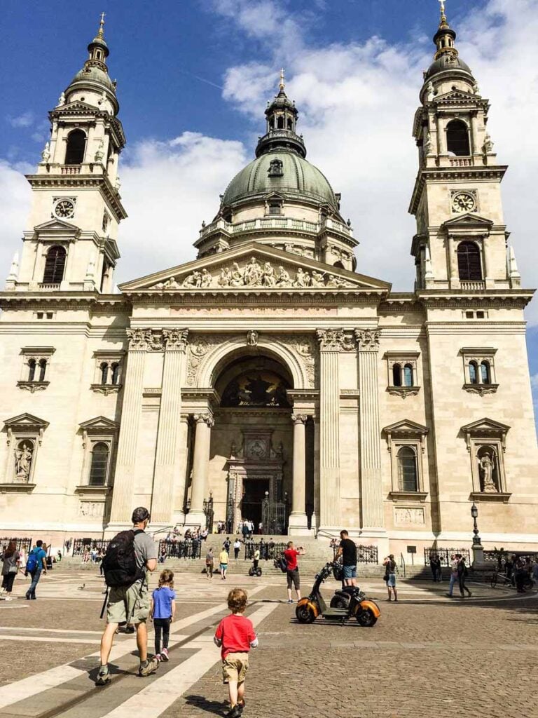 Dan Brewer, owner of FamilyCanTravel.com, visits St. Stephen's Basilica with his kids in Budapest.