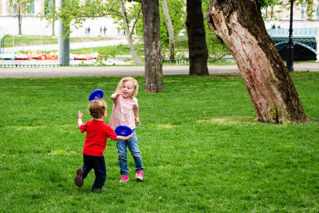 The Brewer kids play with frisbees in City Park in Budapest, Hungary.