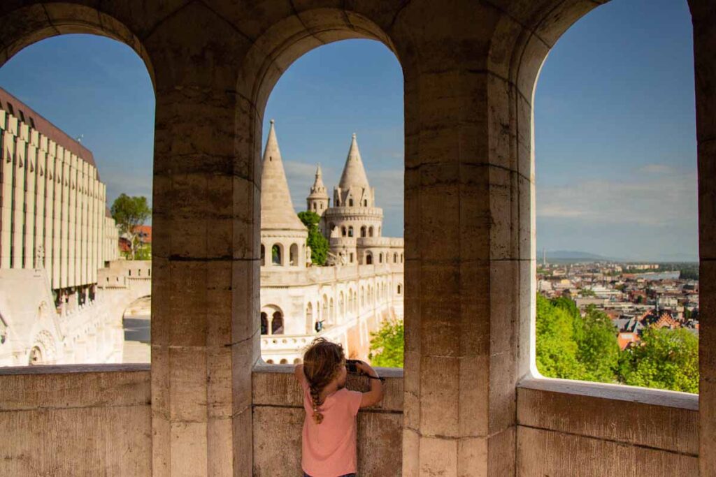 One of the Family Can Travel kids looks at the views from Fisherman's Bastion while on a family trip to Budapest.