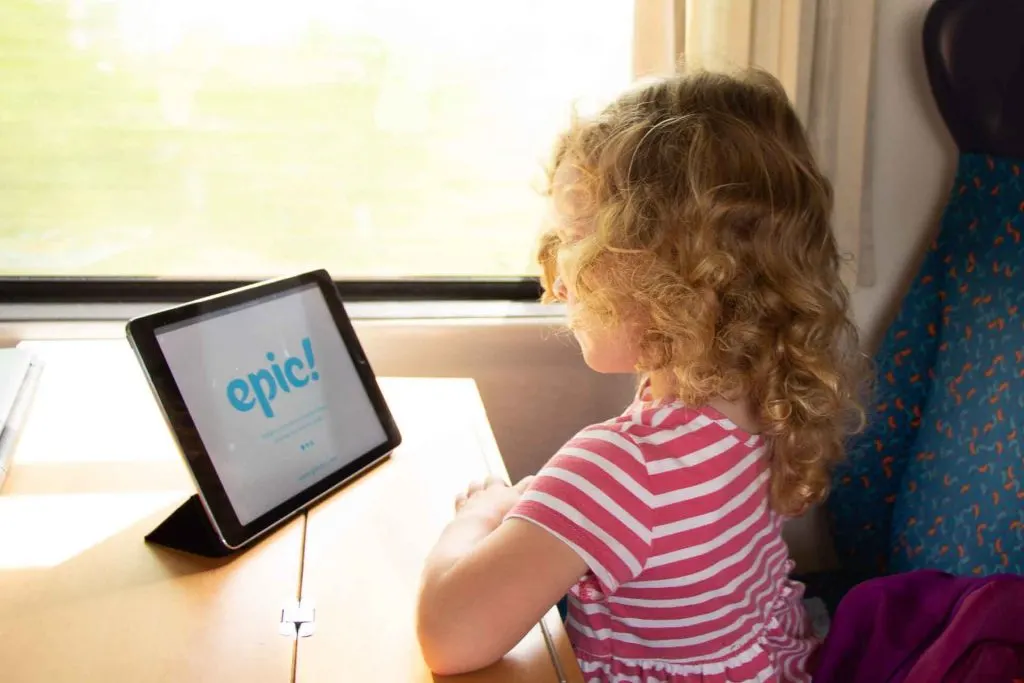A child enjoying the Epic Reading App while traveling