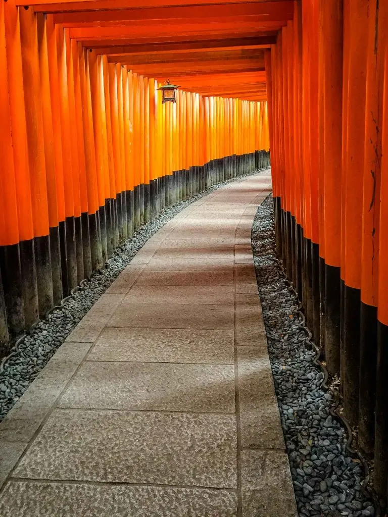 The famous orange and black torii gates at Fushimi Inari Shrine in Kyoto, Japan