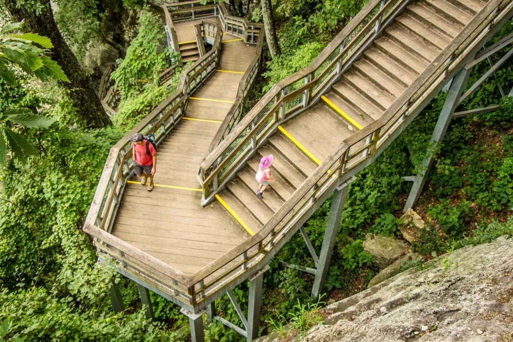 A family stops at Chimney Rock State Park while visiting Asheville with kids.