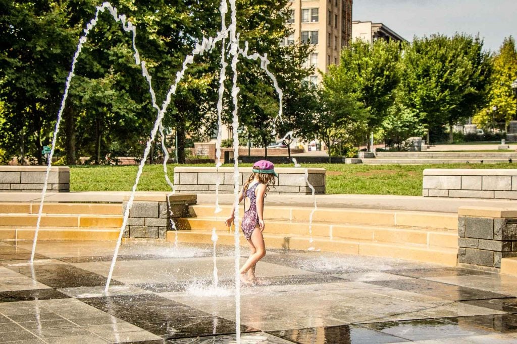 a 5-year old girl plays in the water at Splashville in Asheville, NC.