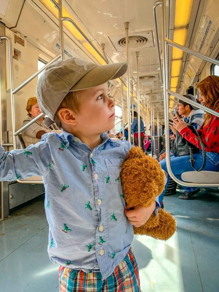 riding the subway in Mexico City with a toddler and his teddy bear