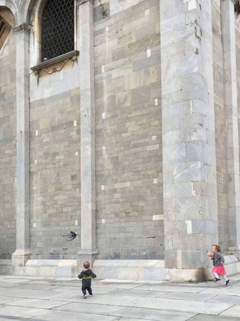 When visiting Pisa with children, be prepared to watch them chase pigeons everywhere