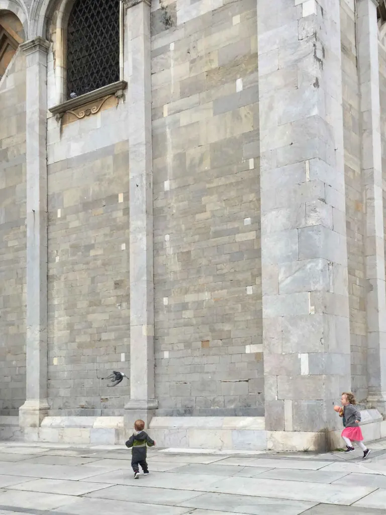 When visiting Pisa with children, be prepared to watch them chase pigeons everywhere