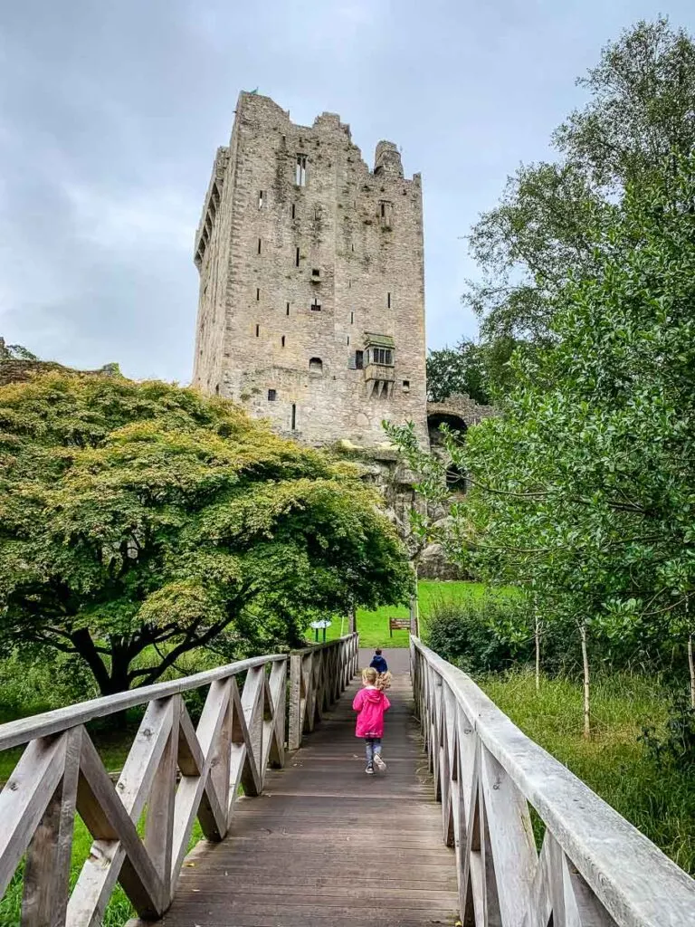 image of children running across bridge towards Blarney Castle