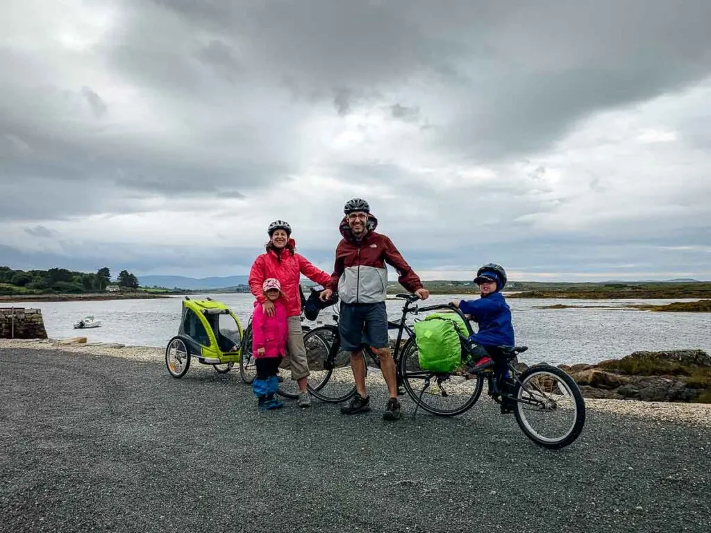 image of family cycling and posing in front of ocean
