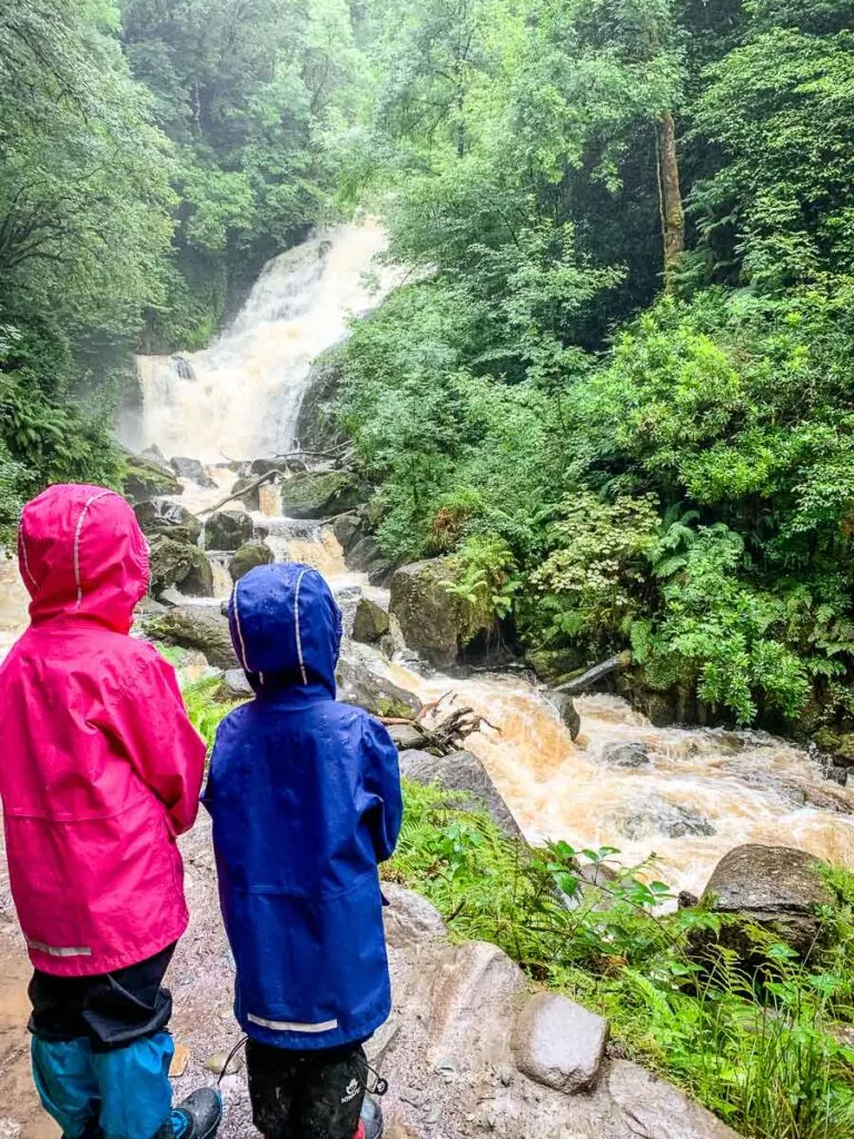 image of two kids looking at Torc Waterfall in Killarney National Park Ireland