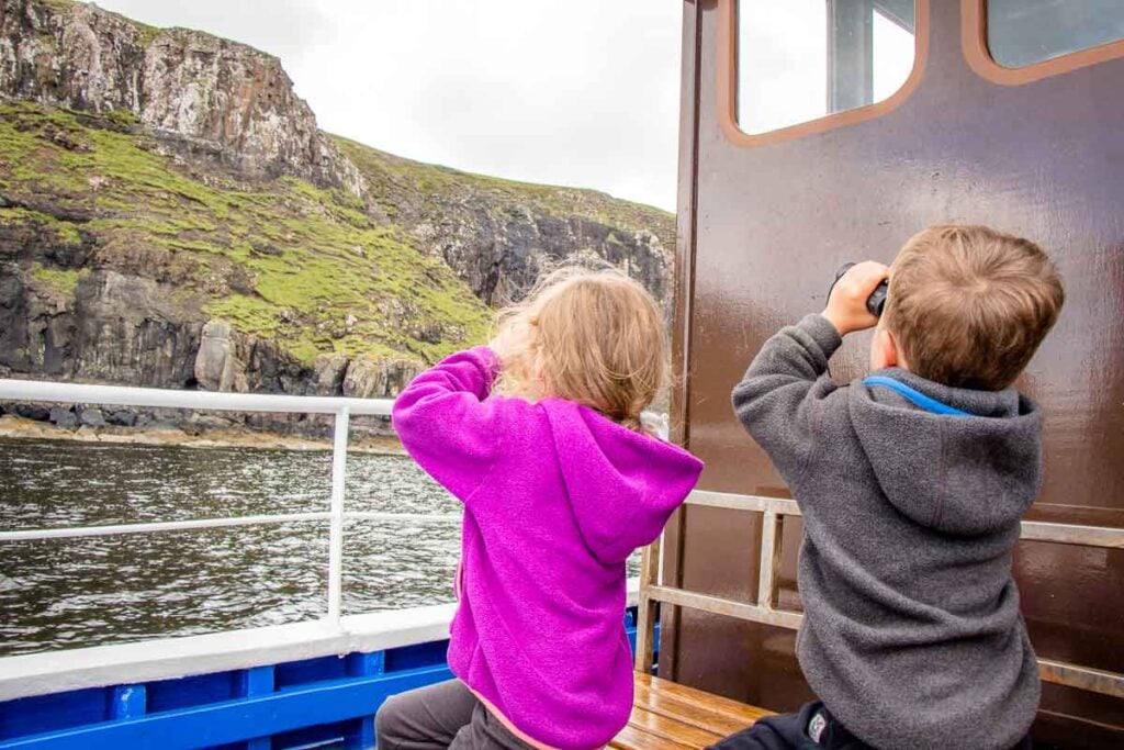 image of two kids with binoculars on a boat cruise isle of skye