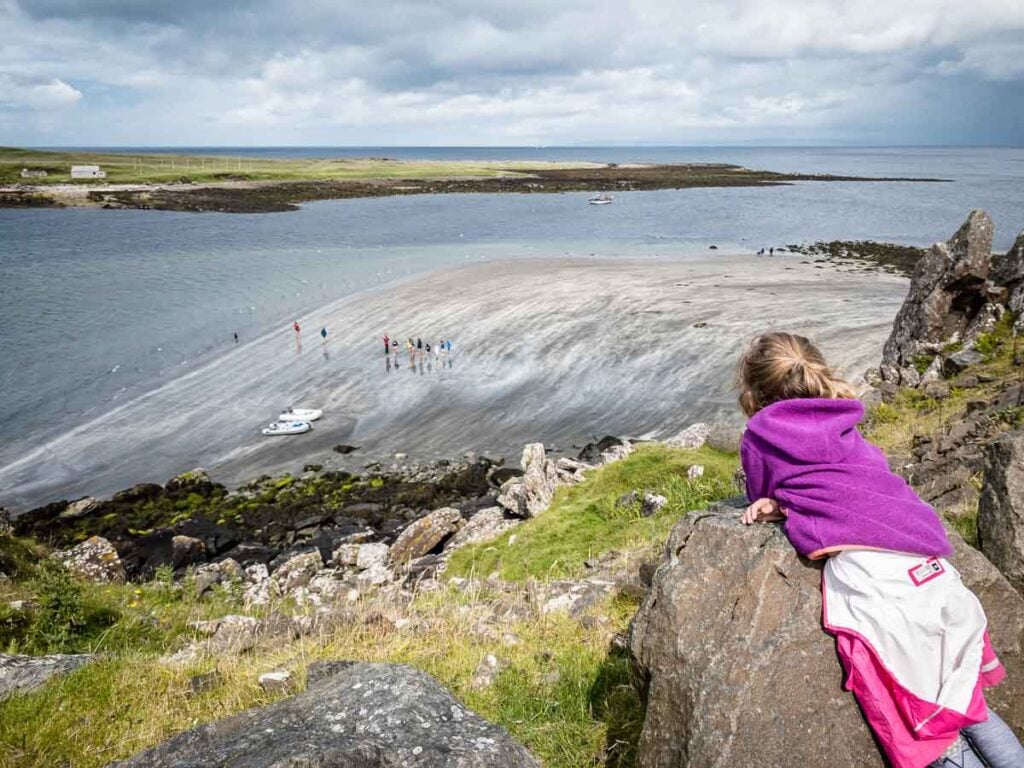 image of girl in purple hoodie looking down on Slipaway Beach