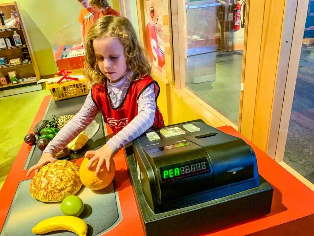 image of girl playing grocery cashier at W5 in Belfast with kids