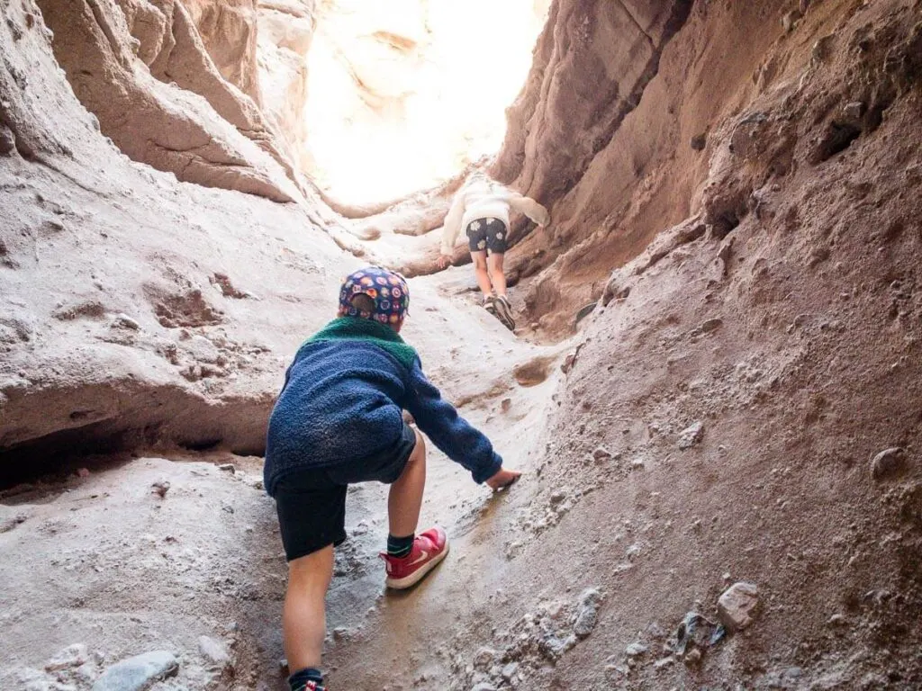 two kids climbing up ladder canyon