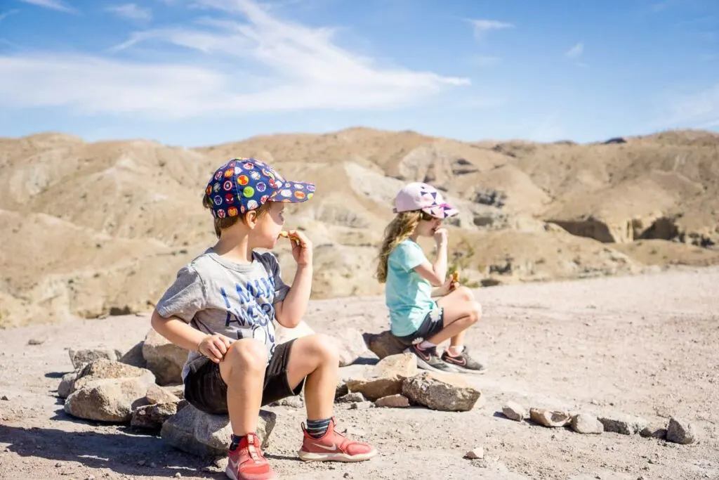 image of two kids eating a snack along Ladder Canyon trail in Palm Springs