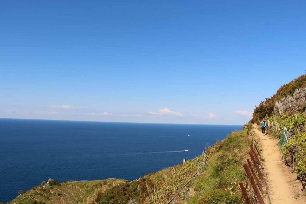 Celine Brewer, owner of Family Can Travel, hiking Cinque Terre with kids on a family vacation to Italy.