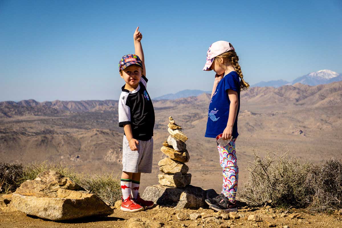 Two kids celebrate hiking to the summit of Ryan Mountain in Joshua Tree National Park