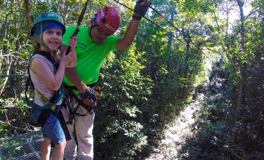 a 4-year old girl loves the ziplines at Aktun Chen Natural Park in the Yucatan Penninsula