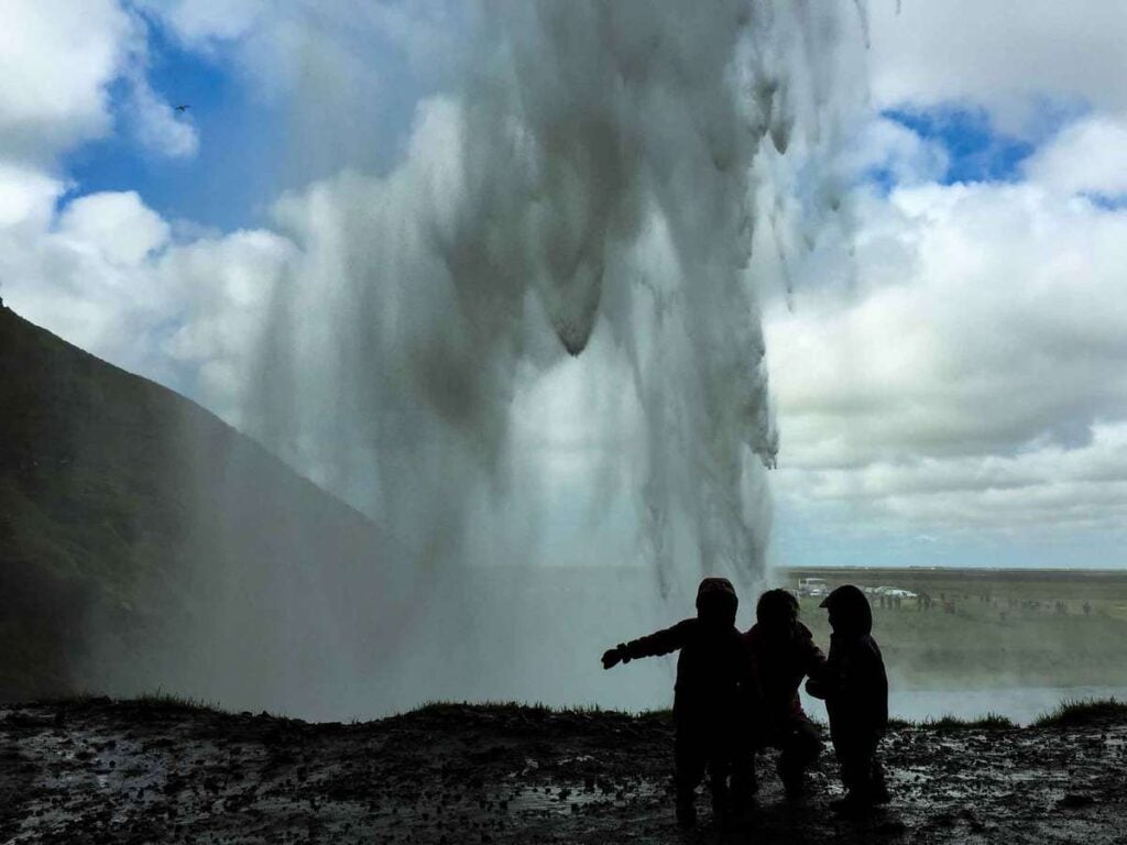 what is there to do in iceland for kids - Walking behind Seljalandsfoss waterfall in South Iceland
