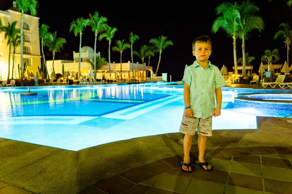 Boy in front of pool - all inclusive family resorts in Cabo
