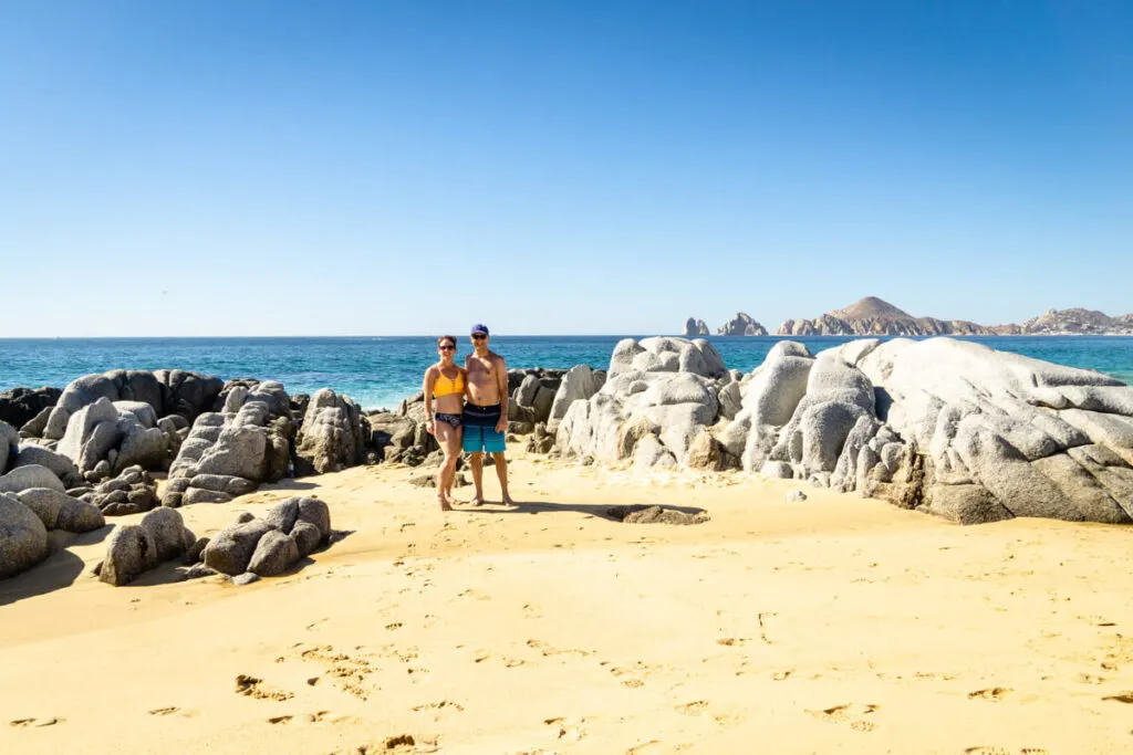 Couple standing in front of ocean on all inclusive family vacation Cabo san Lucas