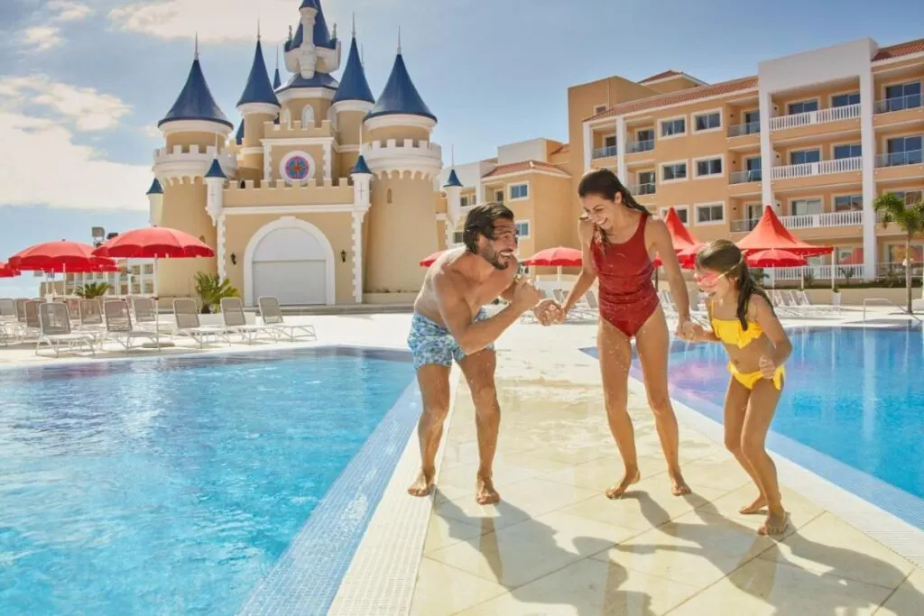 a family plays by the swimming pools at a Tenerife all-inclusive resort