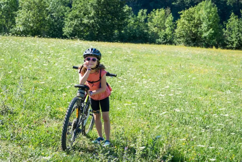 a young girl enjoying a family cycling trip in France along the La Dolce Via trail in Ardeche