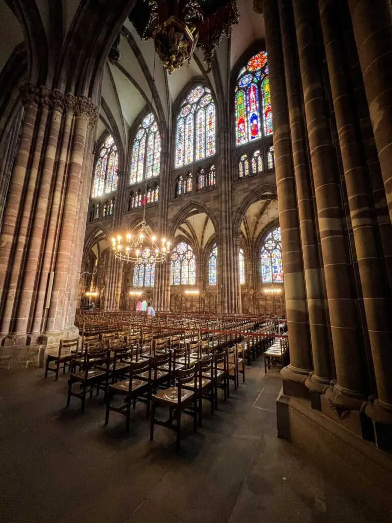 the sun shines through the stained glass windows in the Strasbourg Cathedral
